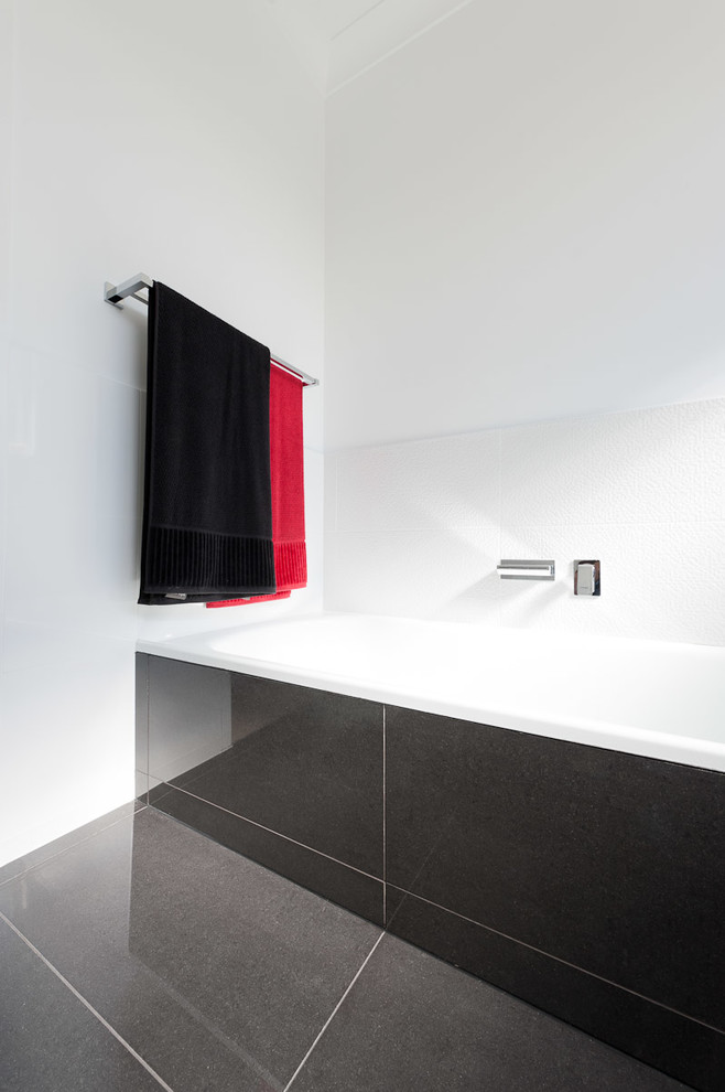Photo of a mid-sized contemporary 3/4 bathroom in Brisbane with a corner tub, porcelain floors and grey floor.