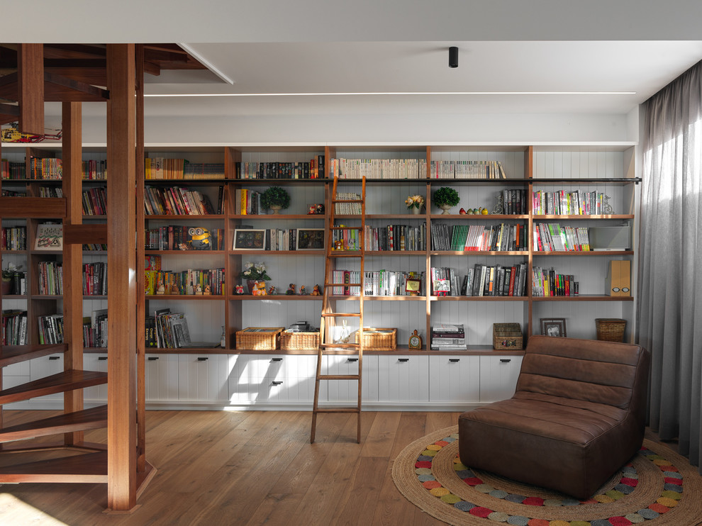 Design ideas for an expansive midcentury open concept family room in Sydney with a library, white walls, light hardwood floors and brown floor.