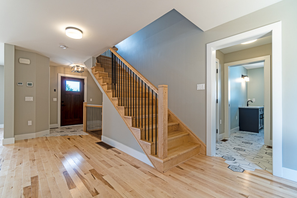 Inspiration for a small transitional ceramic tile and gray floor front door remodel with a brown front door