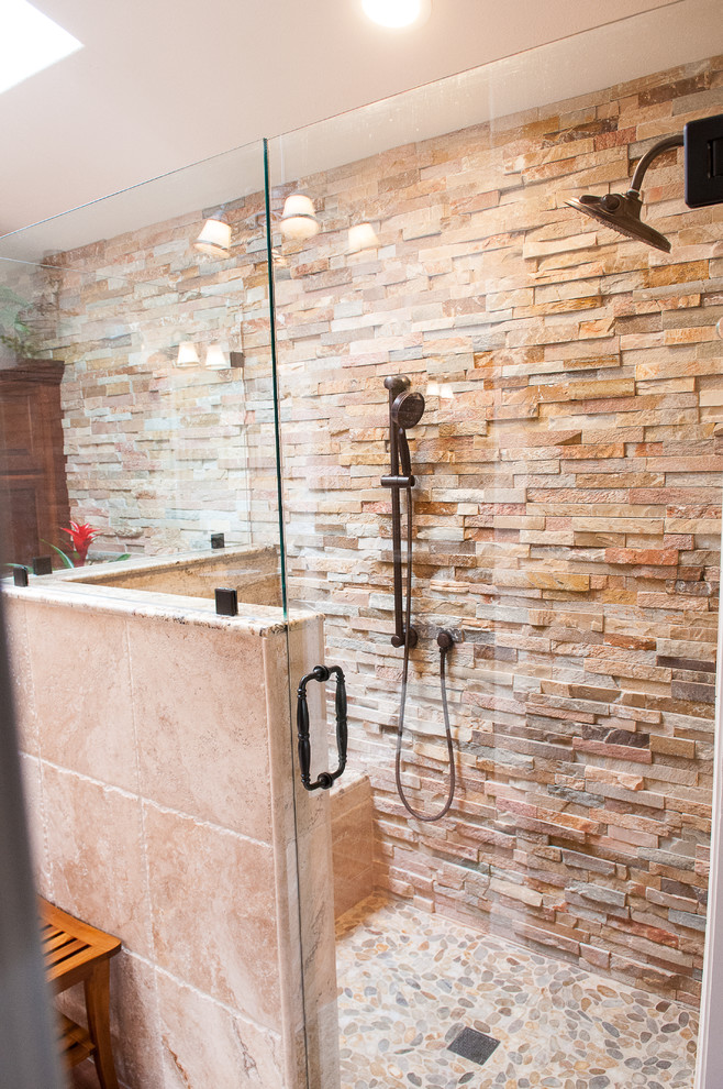 Mid-sized country master bathroom in Other with a corner shower, beige tile, stone tile, beige walls, porcelain floors, beige floor and a hinged shower door.