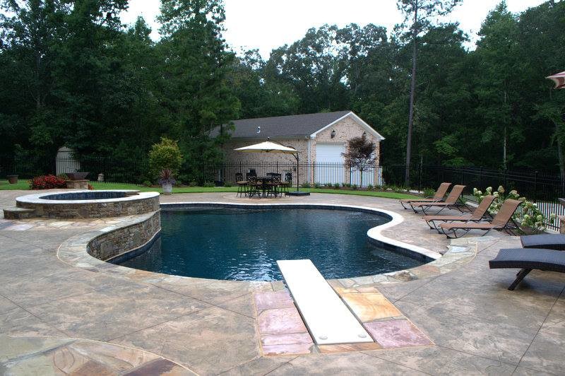 Design ideas for an expansive transitional backyard custom-shaped pool in Atlanta with a hot tub.