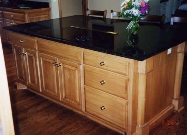 Enclosed kitchen - transitional u-shaped dark wood floor enclosed kitchen idea in Portland with a double-bowl sink, medium tone wood cabinets, granite countertops, stainless steel appliances and an island