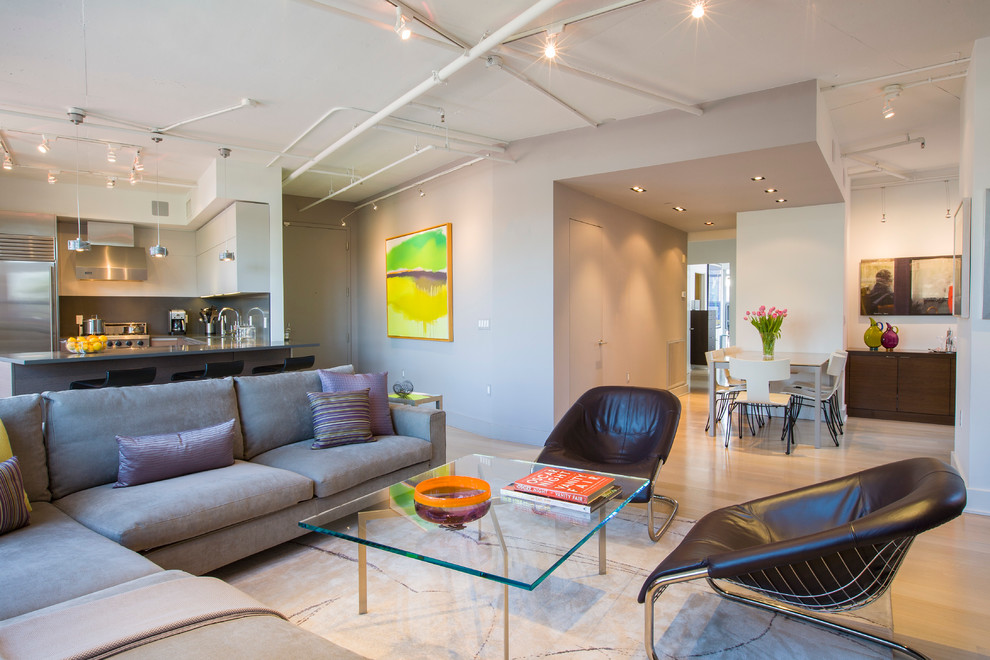 This is an example of a mid-sized modern open concept living room in DC Metro with grey walls and a built-in media wall.