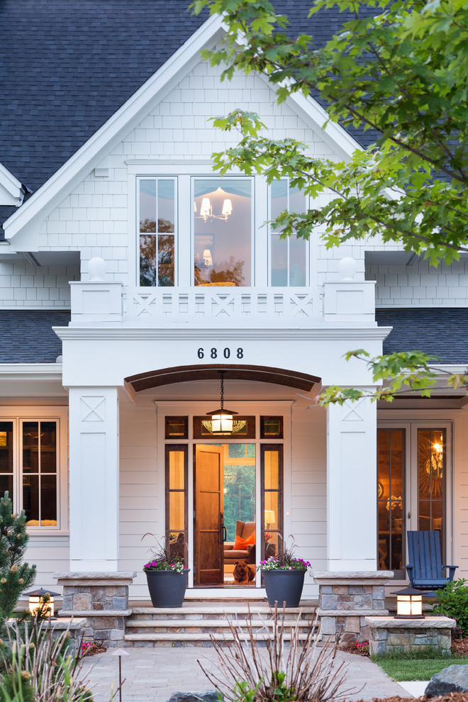 This is an example of a traditional entryway in Minneapolis with a single front door and a dark wood front door.