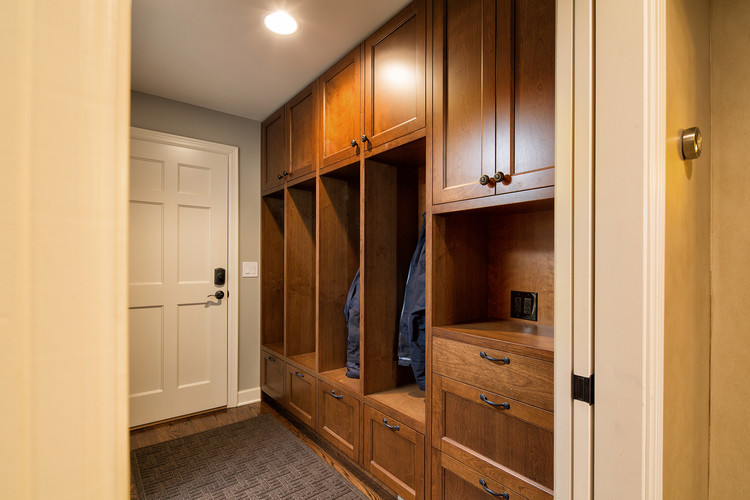 This is an example of a small traditional mudroom in Kansas City with beige walls, medium hardwood floors, a single front door and a white front door.