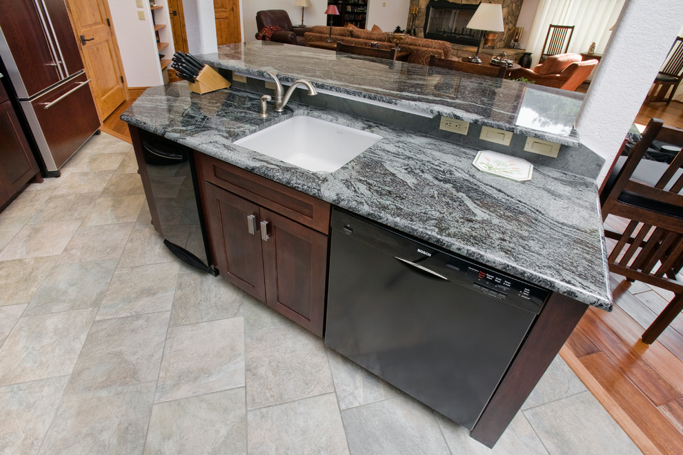 Open concept kitchen - large transitional l-shaped porcelain tile open concept kitchen idea in Denver with an undermount sink, shaker cabinets, red cabinets, granite countertops, gray backsplash, stone tile backsplash, black appliances and an island