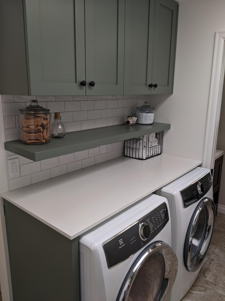 Photo of a medium sized traditional u-shaped utility room in Vancouver with a submerged sink, shaker cabinets, beige cabinets, engineered stone countertops, white splashback, porcelain splashback, ceramic flooring, beige floors, white worktops and a vaulted ceiling.