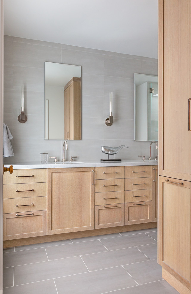 Mid-sized transitional master bathroom in San Francisco with recessed-panel cabinets, light wood cabinets, a corner shower, a one-piece toilet, gray tile, ceramic tile, grey walls, ceramic floors, marble benchtops and an undermount sink.