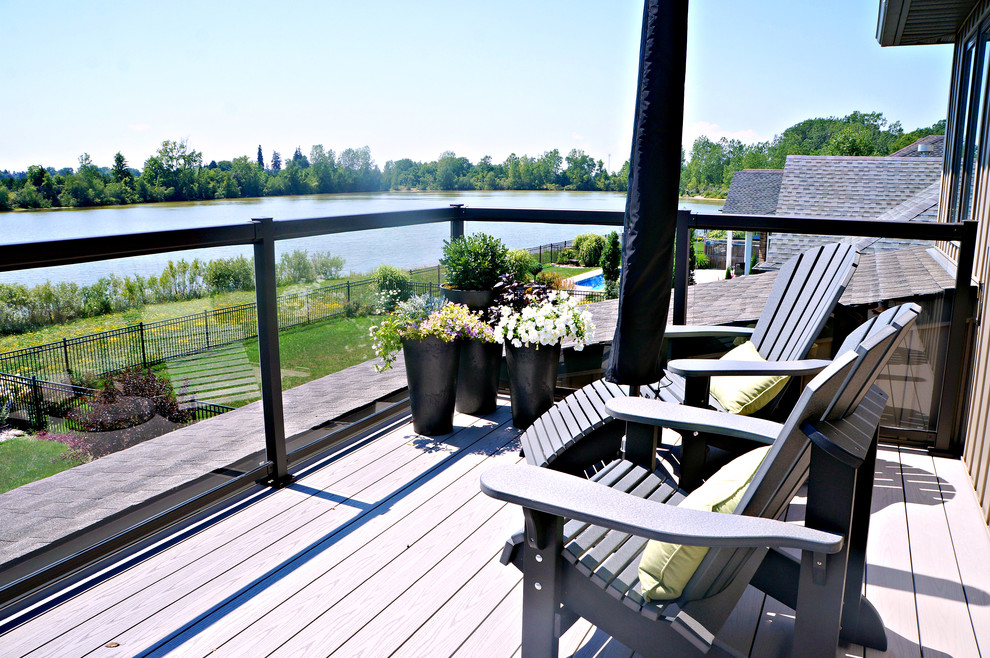Inspiration for a large transitional two-story and backyard vinyl beige deck remodel in Toronto with a hip roof and no cover
