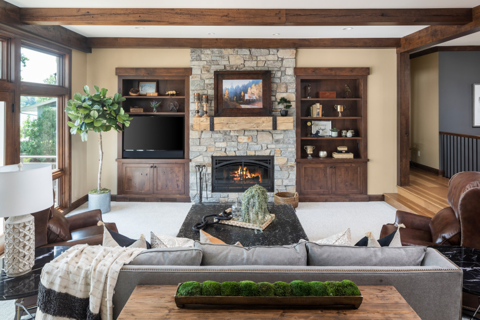 Example of a large mountain style formal living room design in Minneapolis with a standard fireplace, a stone fireplace and a media wall