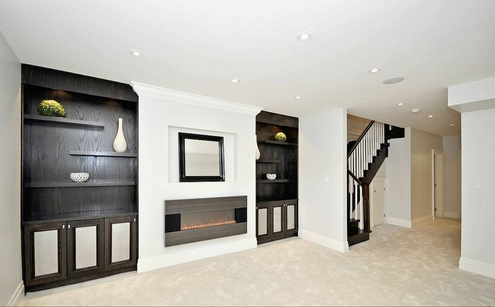 Design ideas for a mid-sized contemporary fully buried basement in Toronto with white walls, carpet, a ribbon fireplace, beige floor and a metal fireplace surround.