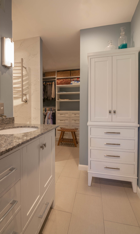 Example of a large transitional master white tile and ceramic tile ceramic tile and beige floor drop-in bathtub design in Atlanta with shaker cabinets, white cabinets, a one-piece toilet, blue walls, an undermount sink and granite countertops