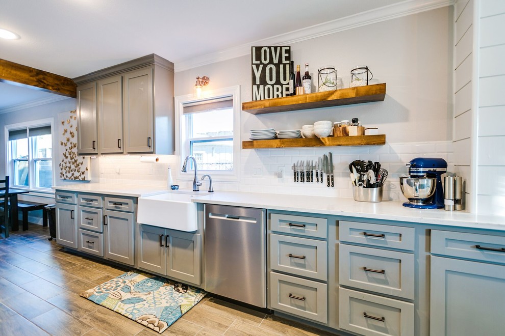 Transitional galley kitchen pantry in Austin with a farmhouse sink, shaker cabinets, grey cabinets, quartz benchtops, white splashback, ceramic splashback, stainless steel appliances and ceramic floors.