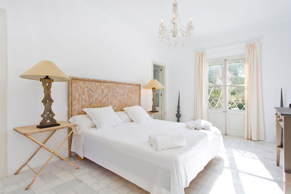 Mid-sized scandinavian master bedroom in Palma de Mallorca with white walls, marble floors and no fireplace.