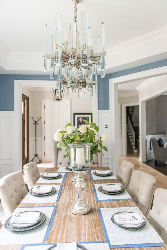 Enclosed dining room - large transitional medium tone wood floor and brown floor enclosed dining room idea in Toronto with blue walls and no fireplace