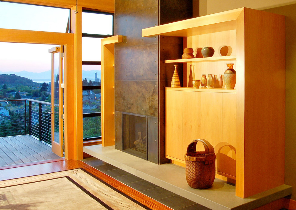 Стильный дизайн: открытая гостиная комната в современном стиле с подвесным камином, фасадом камина из металла и красным полом - последний тренд