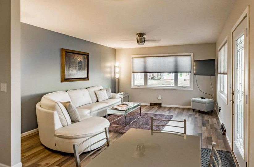 Inspiration for a mid-sized timeless formal and open concept laminate floor living room remodel in Minneapolis with blue walls, a wall-mounted tv and no fireplace