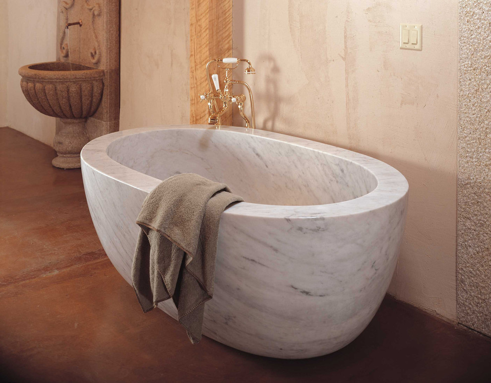 This is an example of a mediterranean bathroom in Detroit with a freestanding tub.