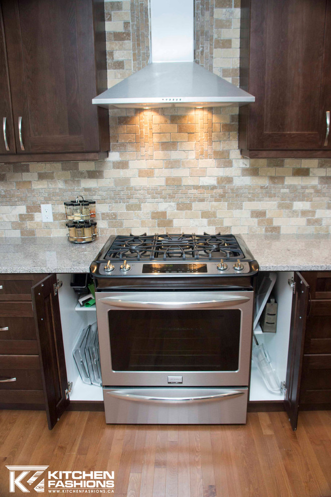 Open concept kitchen - large transitional u-shaped medium tone wood floor open concept kitchen idea with a farmhouse sink, shaker cabinets, dark wood cabinets, quartz countertops, brown backsplash, stone tile backsplash, stainless steel appliances and an island
