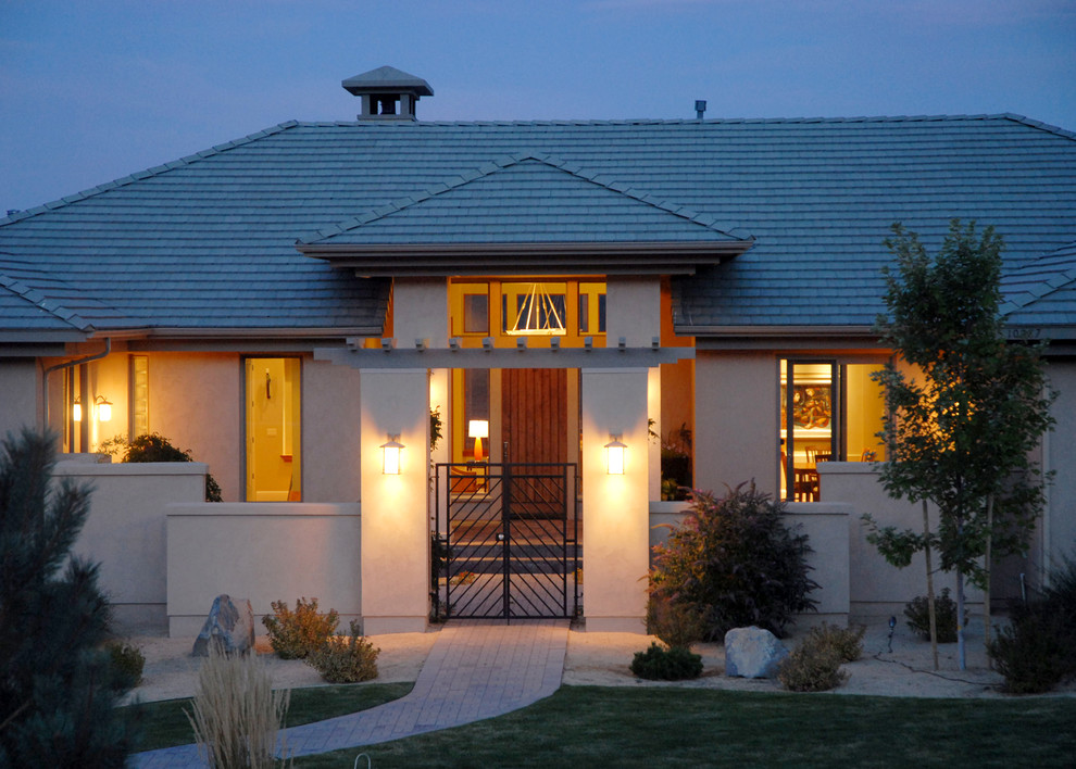 Design ideas for a large one-storey stucco beige house exterior in Other with a hip roof and a shingle roof.