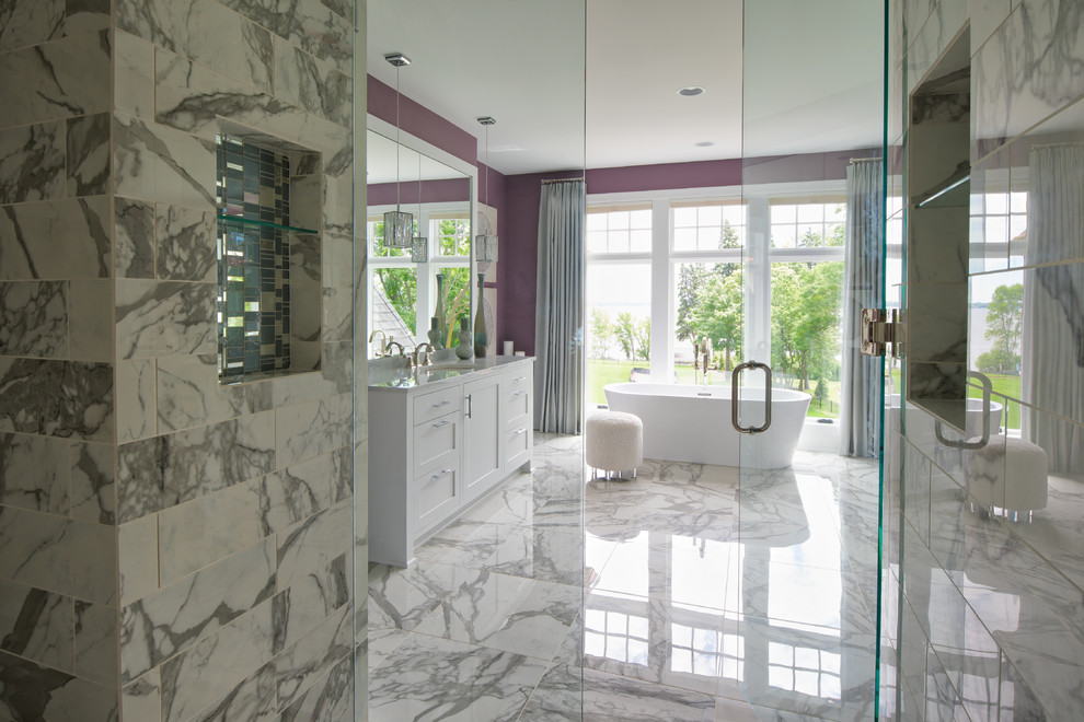 Design ideas for a large transitional master bathroom in Minneapolis with shaker cabinets, white cabinets, a freestanding tub, an alcove shower, gray tile, marble, purple walls, marble floors, an undermount sink, marble benchtops, grey floor and a hinged shower door.
