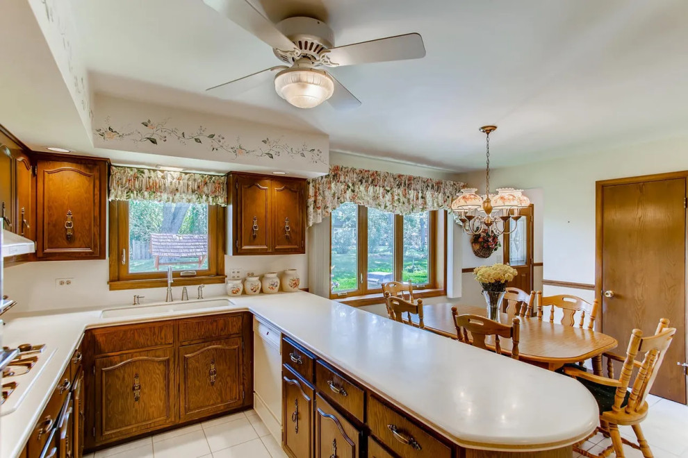 Example of a large minimalist porcelain tile and gray floor kitchen design in Chicago with an undermount sink, flat-panel cabinets, quartzite countertops and white countertops