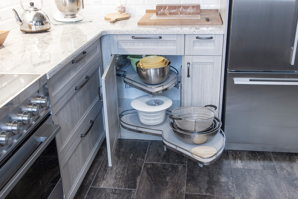Open concept kitchen - mid-sized transitional u-shaped porcelain tile and beige floor open concept kitchen idea in Toronto with an undermount sink, shaker cabinets, light wood cabinets, quartz countertops, white backsplash, subway tile backsplash, stainless steel appliances and a peninsula