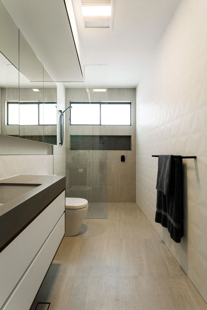Photo of a mid-sized modern master bathroom in Brisbane with flat-panel cabinets, black cabinets, an alcove shower, a two-piece toilet, ceramic tile, white walls, ceramic floors, a drop-in sink, concrete benchtops, an open shower and grey benchtops.