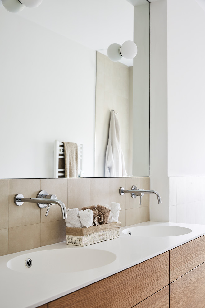 Inspiration for a small contemporary master bathroom in Milan with beaded inset cabinets, medium wood cabinets, a curbless shower, a wall-mount toilet, beige tile, white walls, light hardwood floors, an integrated sink, brown floor and a sliding shower screen.