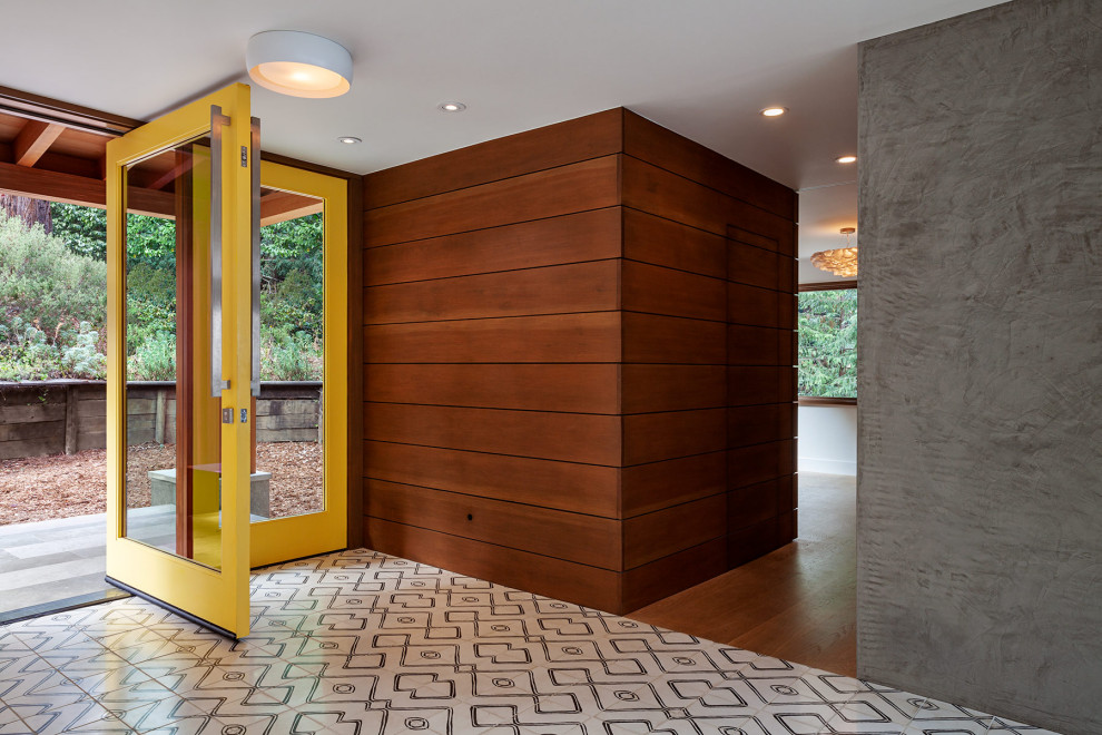 Mid-sized midcentury front door in San Francisco with a pivot front door, a glass front door, grey walls, ceramic floors and multi-coloured floor.