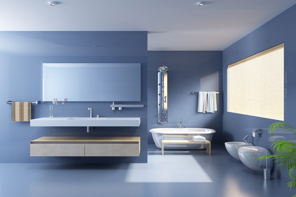 Design ideas for a large modern master bathroom in Los Angeles with flat-panel cabinets, beige cabinets, a freestanding tub, a one-piece toilet, blue tile, porcelain tile, blue walls, ceramic floors, an integrated sink and quartzite benchtops.