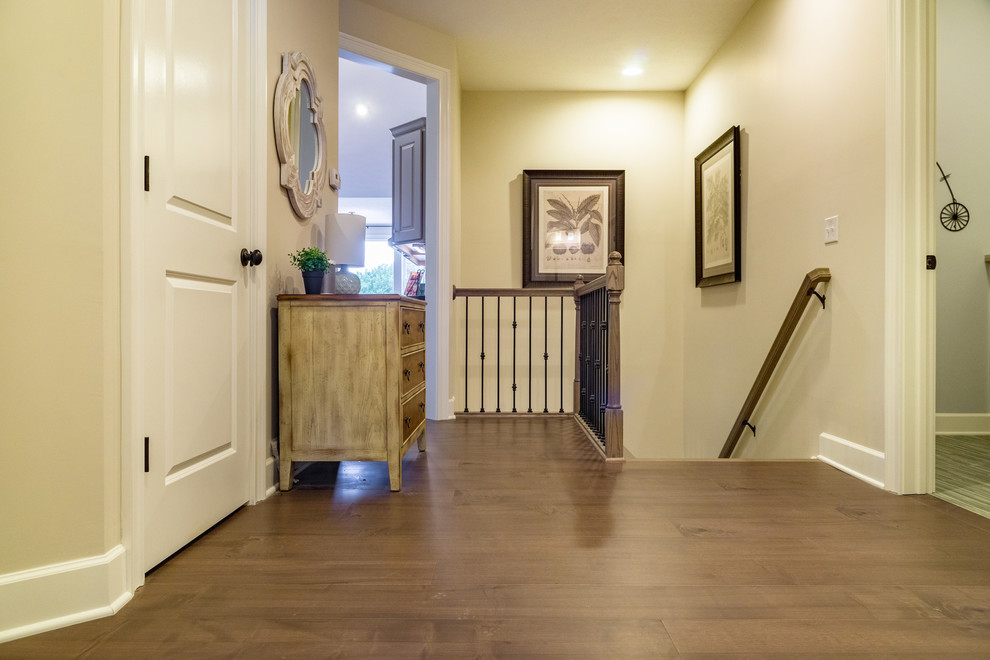 Inspiration for a mid-sized beach style hallway with dark hardwood floors, brown floor and beige walls.
