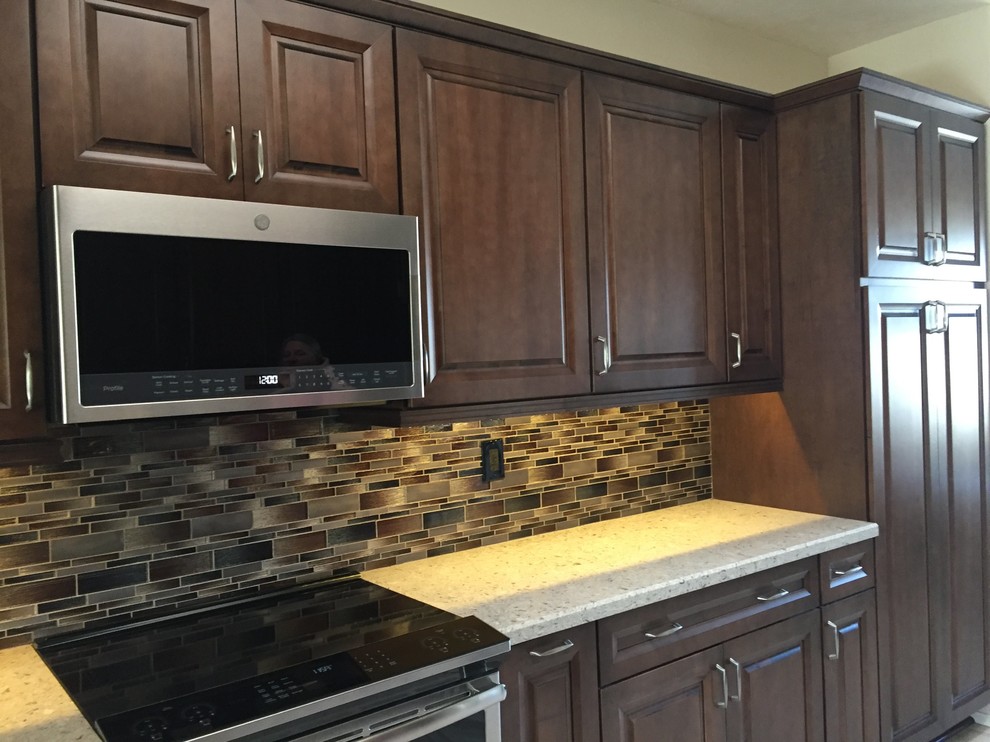 Inspiration for a transitional kitchen remodel in Phoenix with raised-panel cabinets, dark wood cabinets and quartz countertops