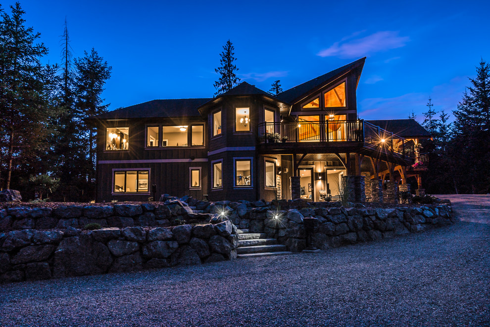 Example of a mid-sized mountain style two-story beige home design design