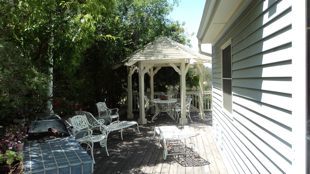 Inspiration for a mid-sized traditional backyard patio in Los Angeles with a fire feature and a gazebo/cabana.