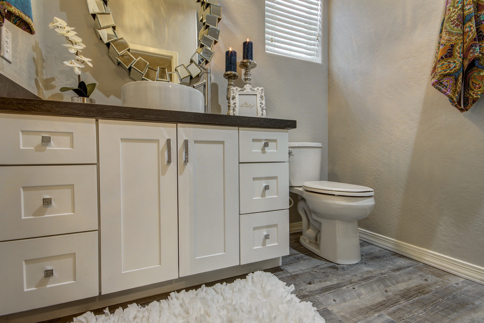 Photo of a small contemporary 3/4 bathroom in Phoenix with shaker cabinets, an open shower, a two-piece toilet, gray tile, grey walls, porcelain floors, a vessel sink and quartzite benchtops.
