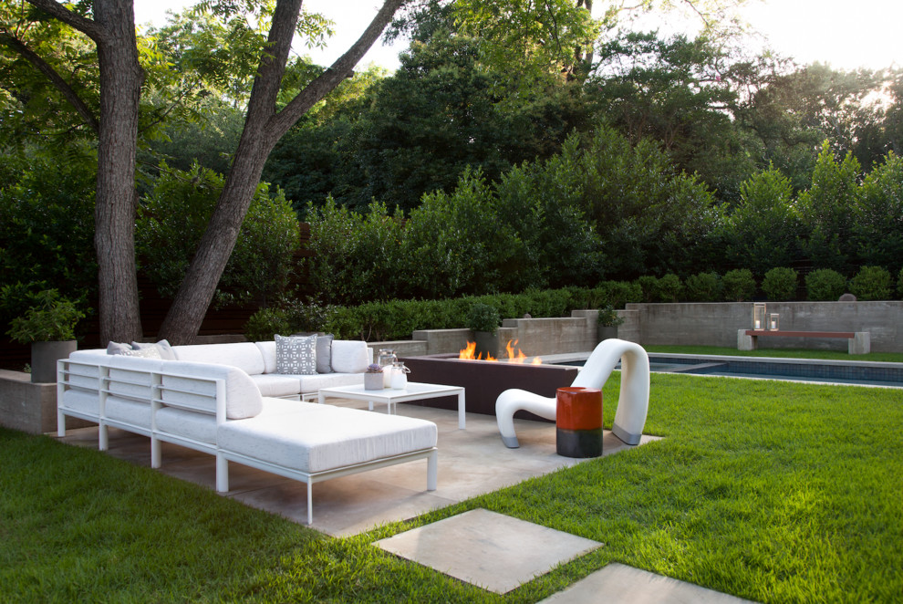 Design ideas for a large modern backyard patio in Austin with a fire feature, concrete slab and no cover.