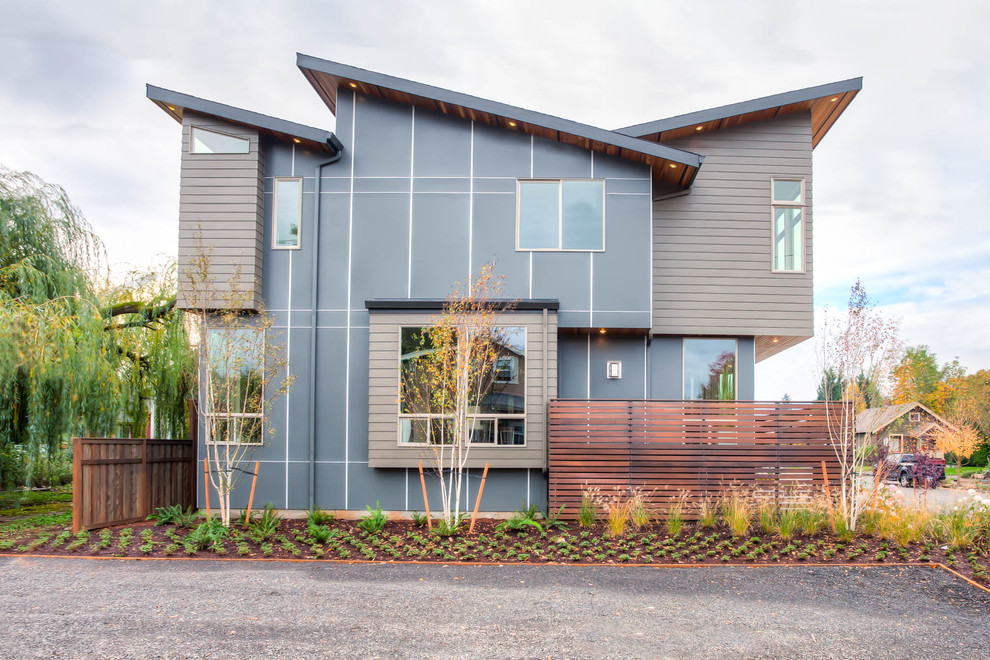 Contemporary two-storey exterior in Portland with mixed siding and a shed roof.