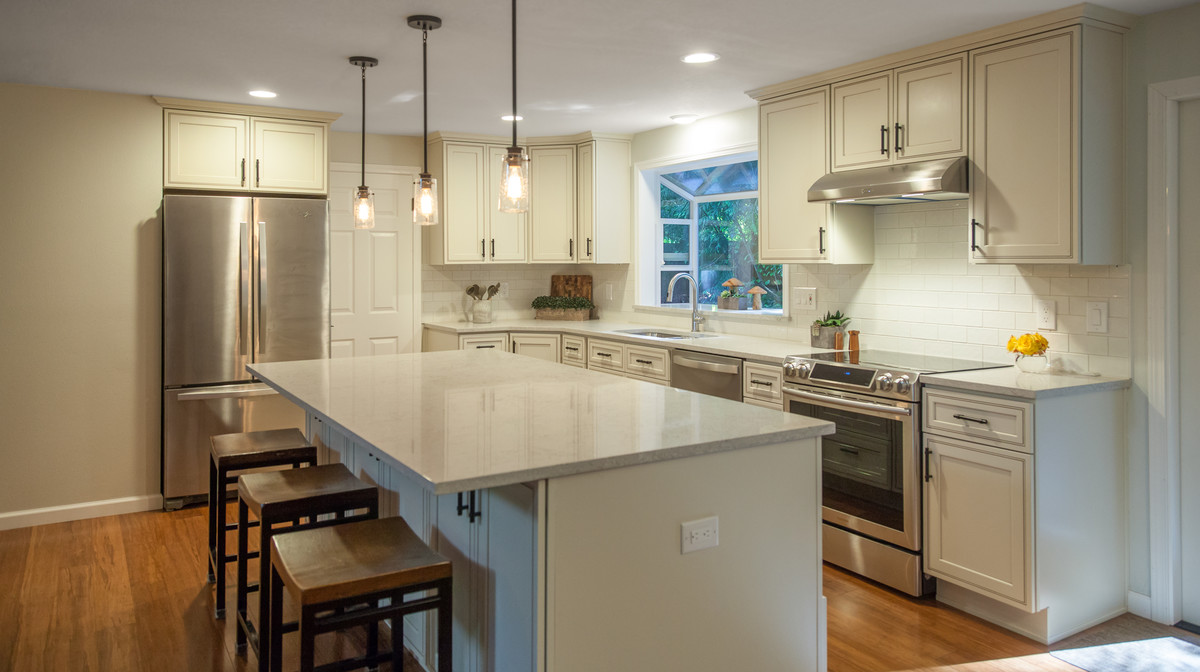 Inspiration for a mid-sized transitional l-shaped bamboo floor and brown floor eat-in kitchen remodel in Seattle with a double-bowl sink, recessed-panel cabinets, quartz countertops, white backsplash, ceramic backsplash, stainless steel appliances and an island