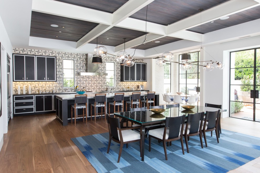Photo of a large contemporary single-wall eat-in kitchen in Orange County with black cabinets, multi-coloured splashback, medium hardwood floors, with island, a farmhouse sink, flat-panel cabinets, marble benchtops, ceramic splashback, stainless steel appliances and brown floor.