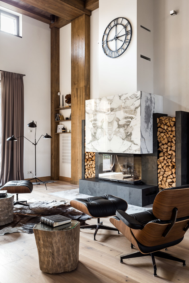 This is an example of an expansive contemporary loft-style living room in Moscow with a music area, white walls, medium hardwood floors, a standard fireplace, a stone fireplace surround, a wall-mounted tv and brown floor.