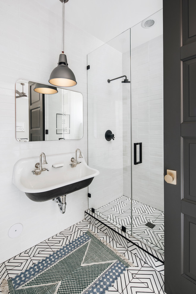 Photo of a mid-sized transitional 3/4 bathroom in Phoenix with white tile, subway tile, a wall-mount sink, white floor, a hinged shower door, shaker cabinets, black cabinets, an open shower, a one-piece toilet, white walls, cement tiles and engineered quartz benchtops.
