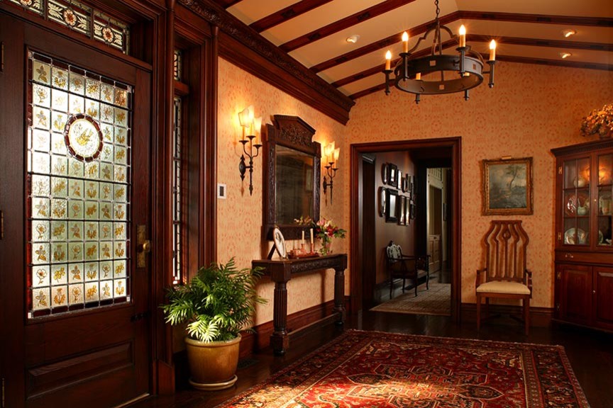 Mid-sized traditional foyer in Other with beige walls, dark hardwood floors, a single front door and a dark wood front door.