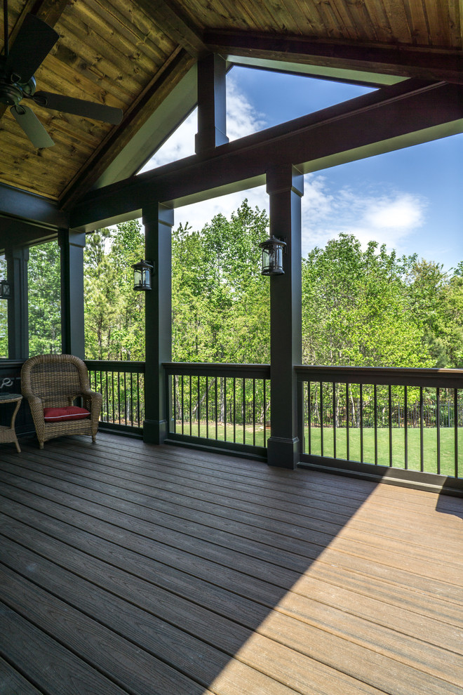 This is an example of a large contemporary backyard deck in Atlanta with an outdoor kitchen and a roof extension.