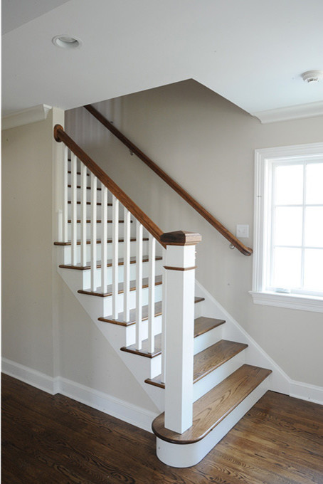 Example of a mid-sized transitional wooden straight wood railing staircase design with painted risers