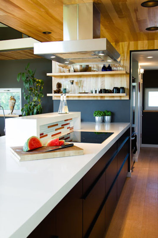 This is an example of a contemporary u-shaped kitchen in Other with a double-bowl sink, flat-panel cabinets, dark wood cabinets, quartz benchtops, orange splashback, ceramic splashback, light hardwood floors and a peninsula.