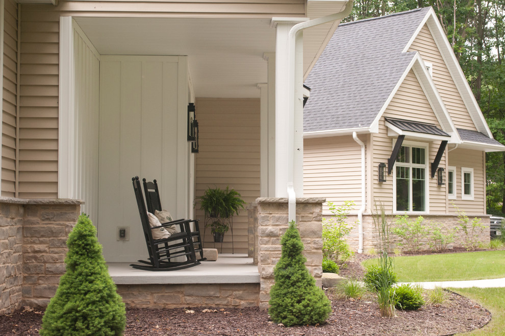 Example of a mid-sized transitional beige two-story vinyl gable roof design with a tile roof