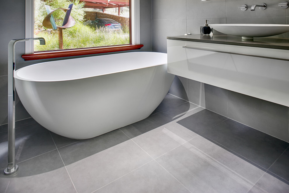Design ideas for a large contemporary master bathroom in Perth with white cabinets, engineered quartz benchtops, a freestanding tub, an open shower, gray tile, ceramic tile, grey walls and ceramic floors.