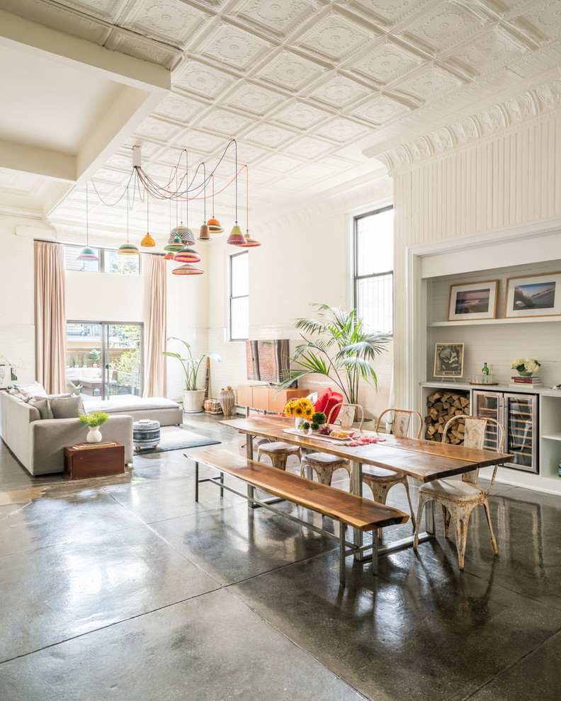 Design ideas for a large eclectic open plan dining in New York with white walls, concrete floors and grey floor.