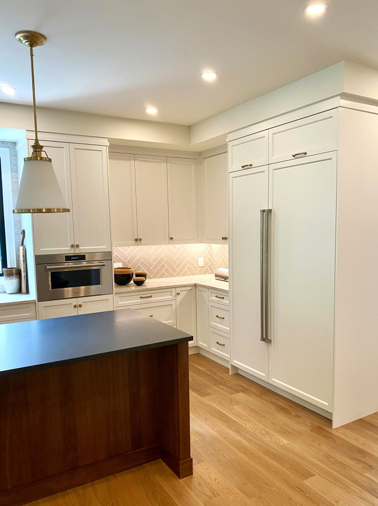 Large transitional l-shaped light wood floor open concept kitchen photo in Toronto with an undermount sink, recessed-panel cabinets, white cabinets, quartz countertops, paneled appliances and an island